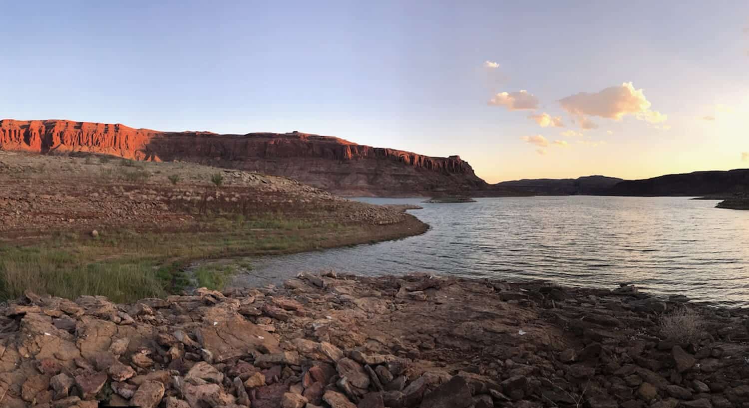 View of red rock formations with the sun glistening off half and other in the shade.