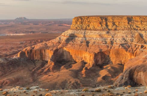 view looking out across open area with red rock formations surrounding under overcast sky